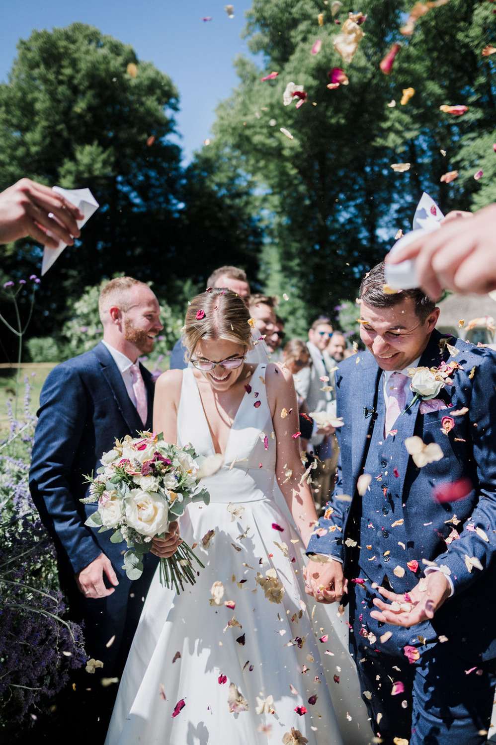 Liberty Pearl Photo & Film Collective Devon Wedding Photography at Deer Park Country House. Bride and groom showered in confetti. 