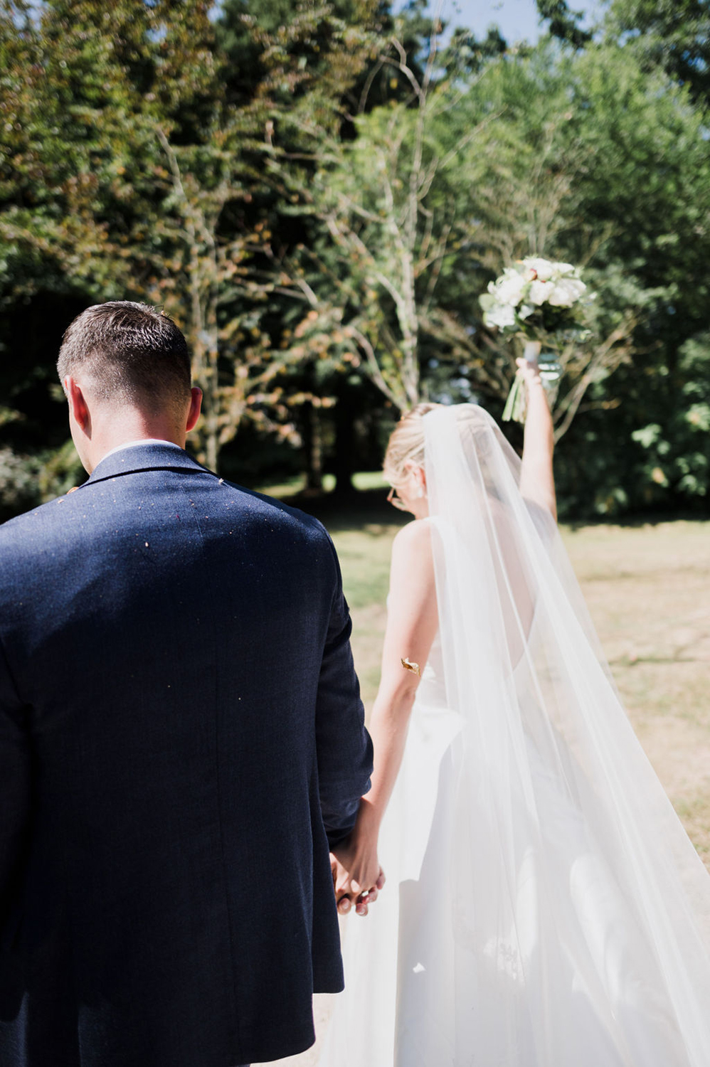 Liberty Pearl Photo & Film Collective Devon Wedding Photography at Deer Park Country House. Bride and groom hold hands.