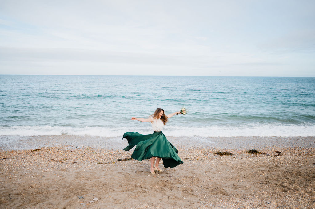 Rustic barn wedding photography by Liberty Pearl Photo & Film Collective. Bride on the beach with flowers.