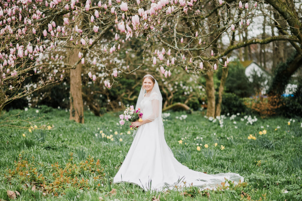 A bride standing in the gardens of Roswarne in Cornwall