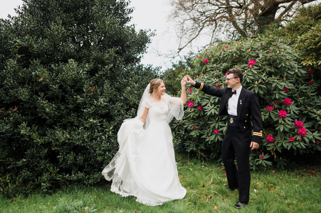A newlywed couple dancing in the gardens at Roswarne in Cornwall